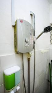 a shower in a bathroom with a green box on the wall at Palm Court in Tanjong Tokong +86 photos