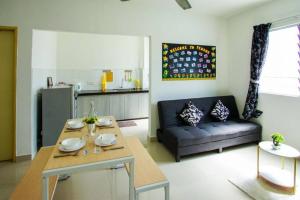 a living room with a table and a couch at Palm Court in Tanjong Tokong