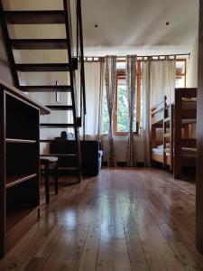 a living room with a staircase and bunk beds at Prestranek Castle Estate in Postojna