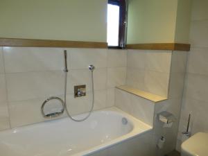 a bath tub with a shower in a bathroom at Holiday Home Jung by Interhome in Gröbming