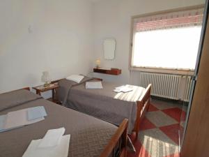 A bed or beds in a room at Apartment Lungolago by Interhome