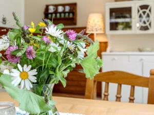 a vase filled with flowers on a table at Holiday Home Richter by Interhome in Zistl +18 photos