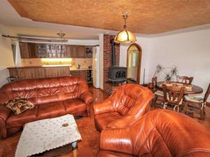 a living room with leather furniture and a table at Holiday Home Jaroslav - DEH130 by Interhome in Dehtáře