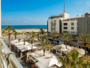 a view of a resort with palm trees and the beach at Apartment La Palme d'Or-16 by Interhome in Cap d'Agde