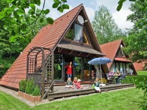 a group of children sitting on the porch of a play house at Holiday Home Winnetou by Interhome in Machtlos