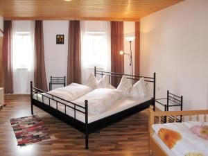 a bedroom with two beds with white pillows at Holiday Home Triendl by Interhome in Bischofsmais