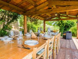 a wooden table and chairs under a wooden pergola at Holiday Home Podere Le Coste by Interhome in Paterna