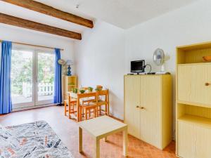 a living room with a table and a dining room at Apartment Les Mas de la Garrigue I et II-1 by Interhome in Cap d'Agde