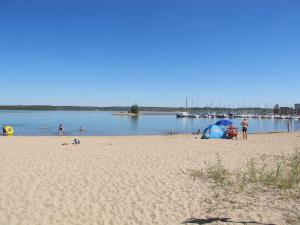 a group of people on a beach with a body of water at Holiday Home Dünenhaus Familia Comfort by Interhome in Großpösna