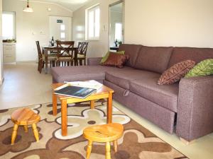 a living room with a couch and a table at Apartment Perisa by Interhome in Grebaštica