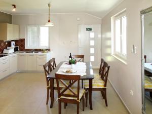 a kitchen and dining room with a table and chairs at Apartment Perisa by Interhome in Grebaštica