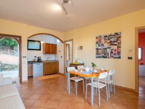 a kitchen and dining room with a table and chairs at Apartment Mimosa - VLO200 by Interhome in Lecchiore