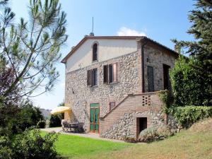 Fattoria SpedalettoにあるApartment Casa Nuova - Volterra - LAI130 by Interhomeの山の上に緑の扉がある古い石造りの建物