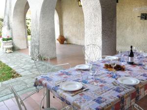 a table with glasses and a bottle of wine at Holiday Home La Bertolina by Interhome in Torrazzo
