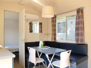 a living room with a table and chairs at Holiday Home Cisano & San Vito-1 by Interhome in Lazise