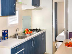 a kitchen with a sink and a stove top oven at Holiday Home Happy Easy by Interhome in Rosapineta