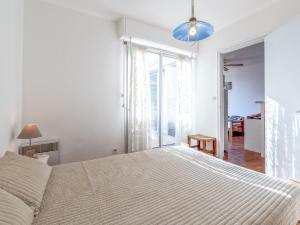 a bedroom with a large bed and a large window at Apartment Le Capri-1 by Interhome in Cap d'Agde