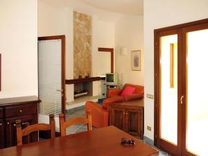 een woonkamer met een tafel en een bank bij Holiday Home Rei Sole - REI300 by Interhome in Costa Rei