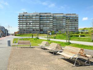 a row of benches in front of a building at Studio Residentie Astrid-5 by Interhome in Bredene