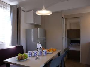 a kitchen with a table with fruits and a refrigerator at Holiday Home Internazionale Manacore by Interhome in Peschici