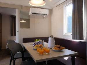 a table with a plate of food and glasses of orange juice at Holiday Home Internazionale Manacore by Interhome in Peschici