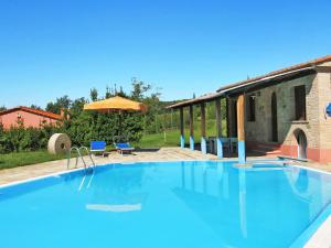 a large swimming pool in a yard with a house at Apartment Le Palaie - 'Padronale' - PEC209 by Interhome in Montecchio