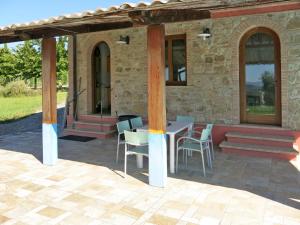 a patio with a table and chairs in front of a building at Apartment Le Palaie - 'Padronale' - PEC209 by Interhome in Montecchio