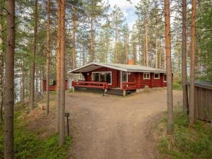 a cabin in the middle of a forest at Holiday Home Pohosniemi by Interhome in Huuhanaho