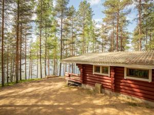 a log cabin in the middle of a forest at Holiday Home Pohosniemi by Interhome in Huuhanaho