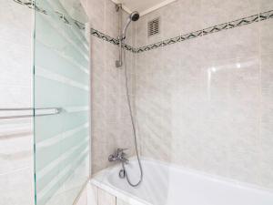 a bathroom with a shower and a tub and a sink at Studio Le Sefcotel - Val Claret-21 by Interhome in Tignes
