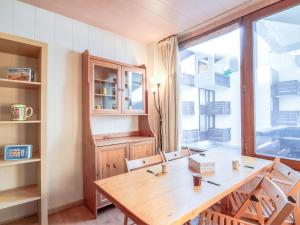 a dining room with a wooden table and a window at Studio Le Sefcotel - Val Claret-21 by Interhome in Tignes