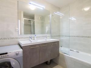 a bathroom with a sink and a washing machine at Apartment Bella Vista by Interhome in Cap d'Agde