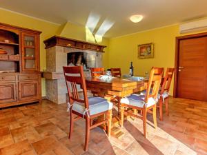 a kitchen with a table and chairs and a fireplace at Holiday Home Dante by Interhome in Marčelji