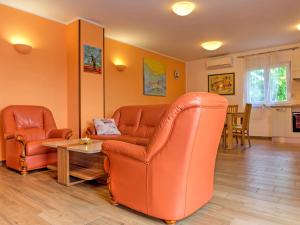 a living room with two leather chairs and a table at Holiday Home Dante by Interhome in Marčelji