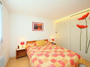カップ・ダグドにあるApartment Les Mas de la Garrigue I et II-6 by Interhomeのベッドルーム1室(赤い花の壁にベッド1台付)