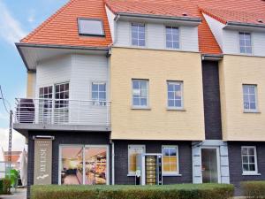 a large house with an orange roof at Apartment Vosseslag II by Interhome in Mispelburg