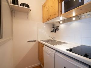 a small kitchen with a sink and a counter top at Studio Le Hameau du Borsat-11 by Interhome in Tignes