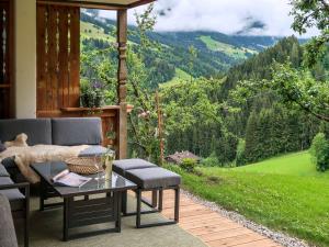 a patio with a table and chairs and a view at Apartment Chalet Edelweiß - WIL001 by Interhome in Auffach