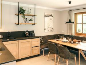 a kitchen with a wooden table and chairs at Apartment Chalet Edelweiß by Interhome in Auffach