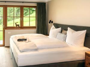 a large white bed in a room with a window at Apartment Chalet Edelweiß by Interhome in Auffach