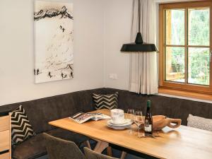 a dining room table with a bottle of wine on it at Apartment Chalet Edelweiß by Interhome in Auffach