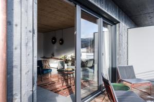 a room with sliding glass doors leading to a patio at Pförtner Penthouse in Hausham