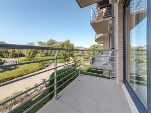 a balcony with a view of a street at Apartment Goldsands II 101 with garage by Interhome in De Haan