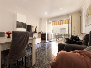 a living room with a couch and a table at Holiday Home Llaberia by Interhome in Torredembarra +39 photos