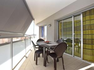 a balcony with a table and chairs on it at Apartment Oliveres by Interhome in Torredembarra