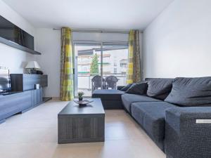 a living room with a couch and a coffee table at Apartment Oliveres by Interhome in Torredembarra