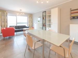 comedor y sala de estar con mesa blanca y sillas en Apartment Seaside by Interhome, en Bredene