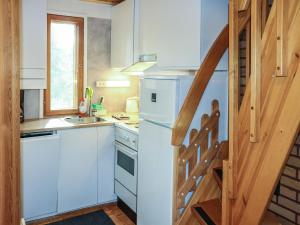 a kitchen with a white refrigerator and a sink at Holiday Home Villa tassu 1 by Interhome in Kotila