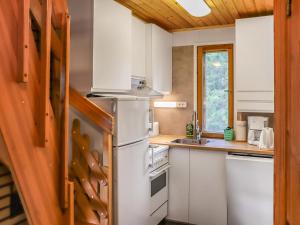 eine Küche mit Kühlschrank und Spüle in der Unterkunft Holiday Home Villa tassu 2 by Interhome in Kotila