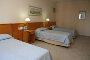 Postel nebo postele na pokoji v ubytování Jaguary Hotel Sumaré